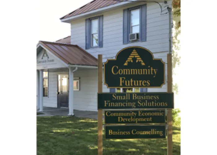 Community Futures building. The picture shows the sign for Community Futures and a white building with a red roof in the background.