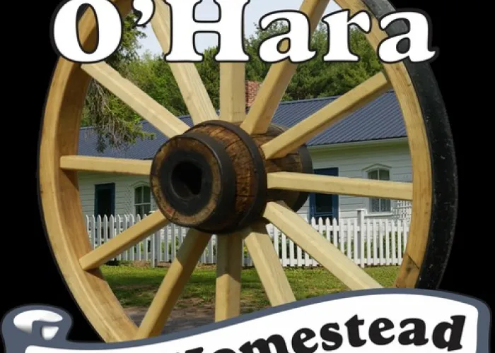 Wagon wheel, image of home visible through spokes, location name