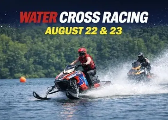 Two water cross racers on lake, trees in background, event date and name
