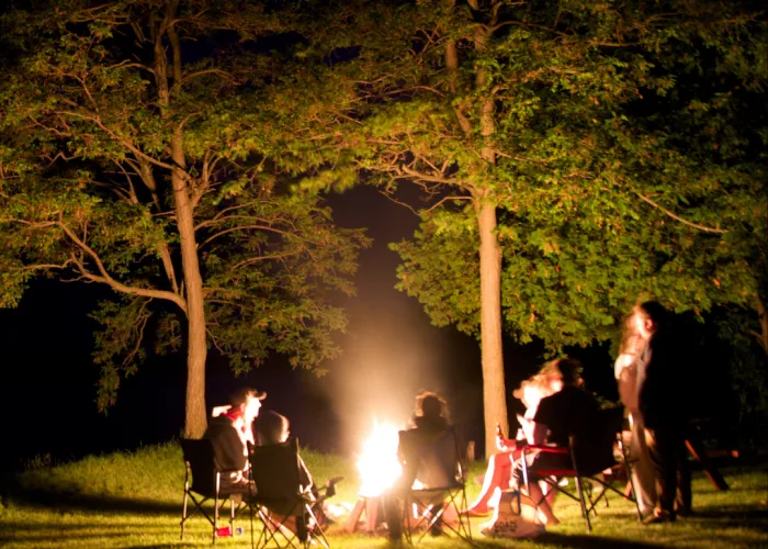 People around a campfire in the dark