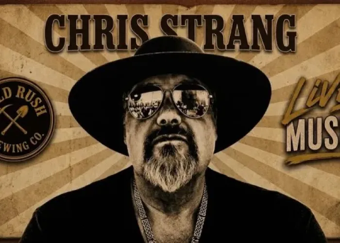 Chris Strang in black and white wearing reflective sunglasses and a wide-brimmed hat. Venue logo and name of event