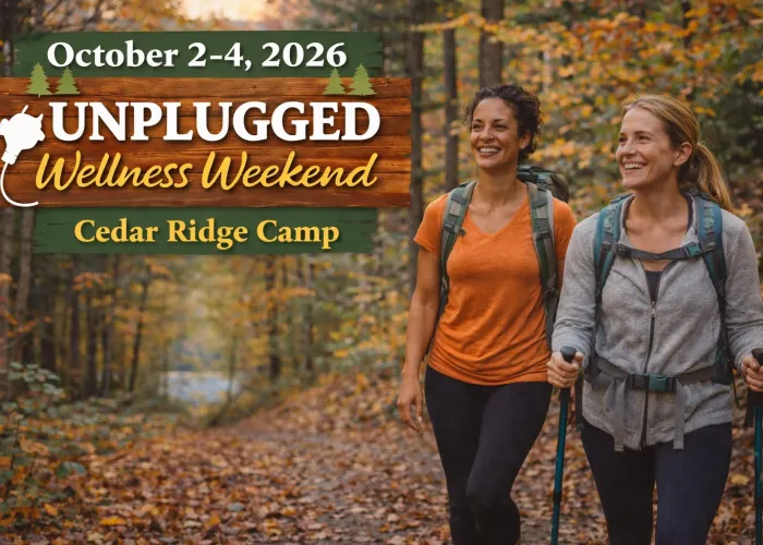 Two women wearing backpacks walking in a forest in the fall, event name and details